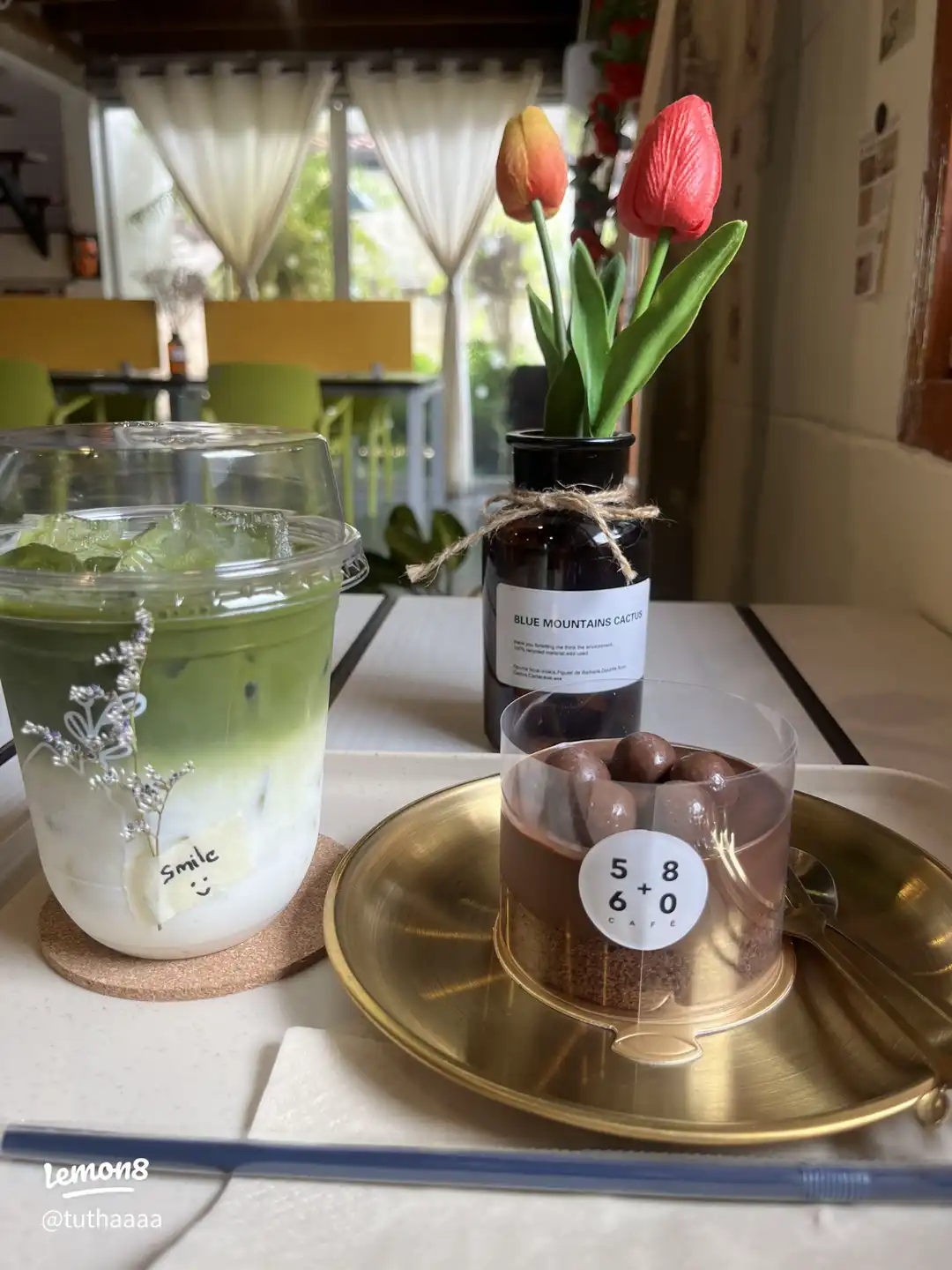 Matcha latte, chocolate cake and flowers at House no.19 cafe